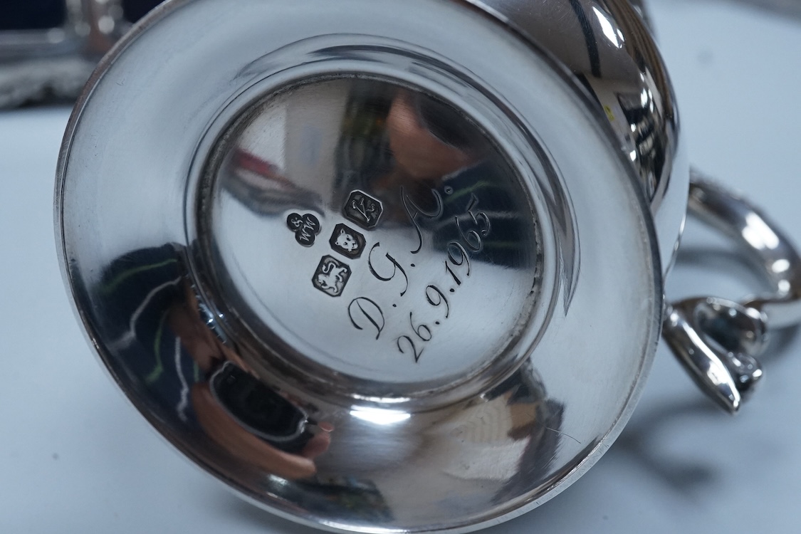 An Elizabeth II silver baluster christening mug, Wakely & Wheeler, London, 1965, with engraved inscription to the base, 10cm, together with two modern silver mounted photograph frames including a double and one other met